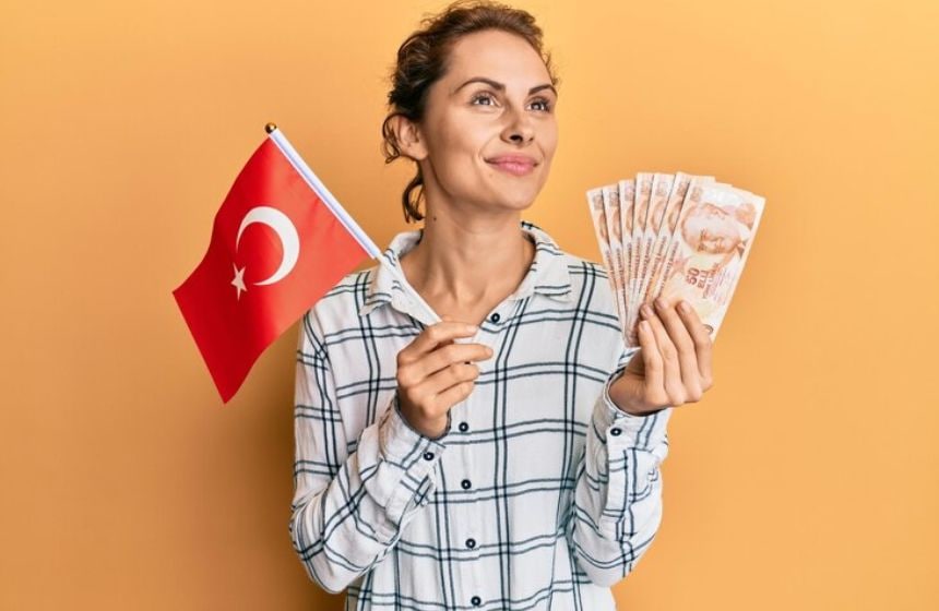 a lady holding turkey flag and turkish lira